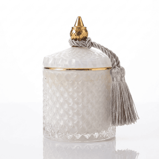 Decorative scented candle in a white and gold crystal glass container
